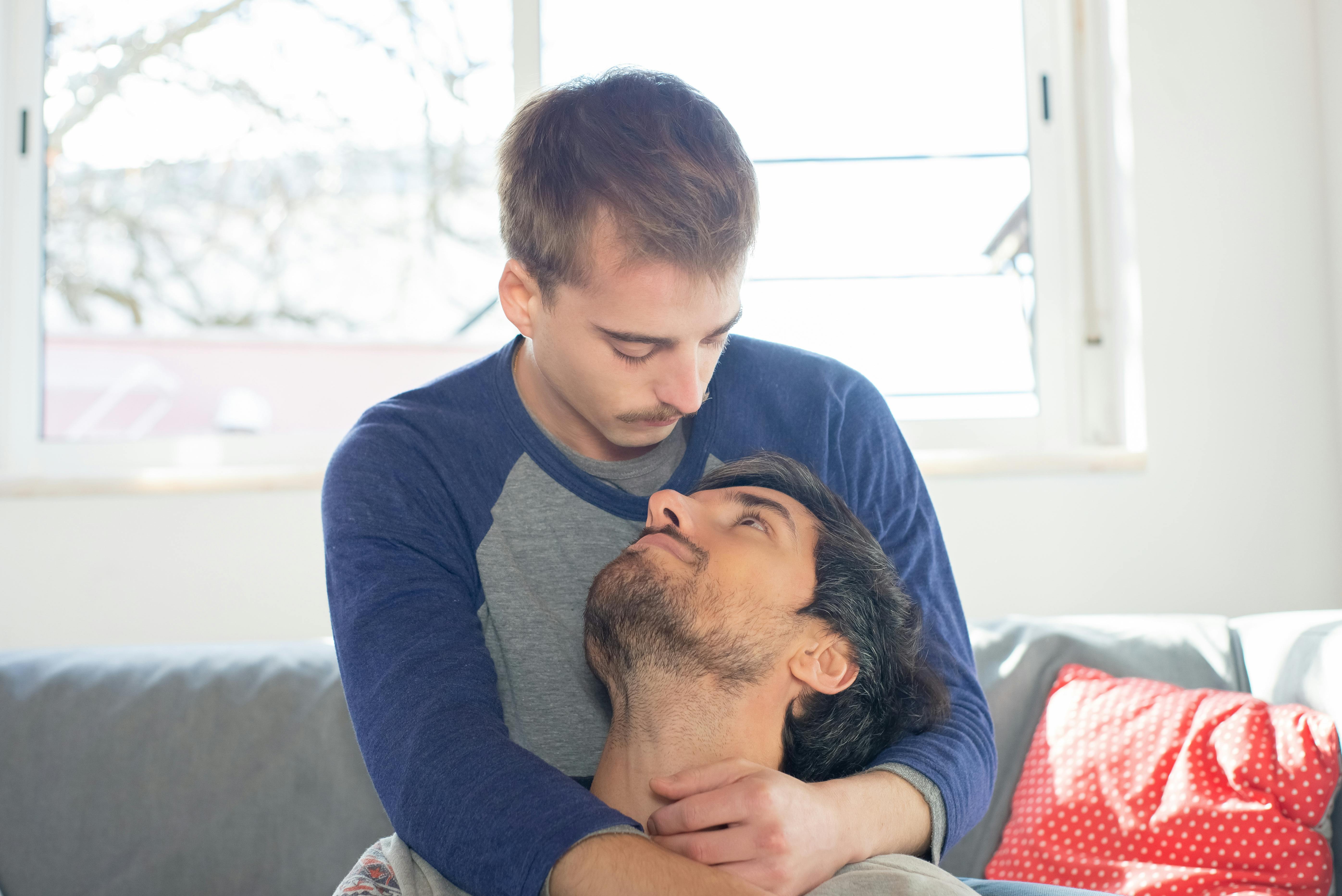 two men holding each other in the living room